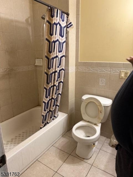 12 Amity Street, Unit 2 Paterson, NJ 07522 - Photo 13 of 14 a white toilet sitting next to a bathroom sink