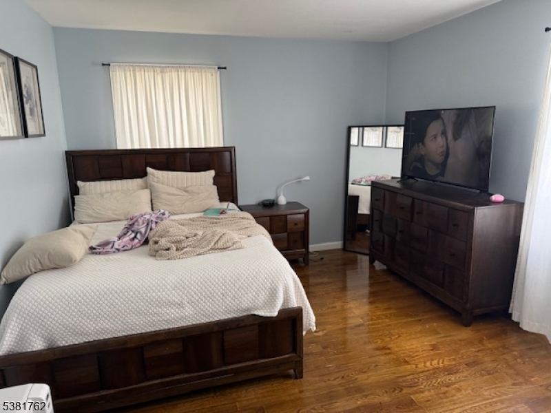 12 Amity Street, Unit 2 Paterson, NJ 07522 - Photo 6 of 14 a bedroom with a bed and wooden floor