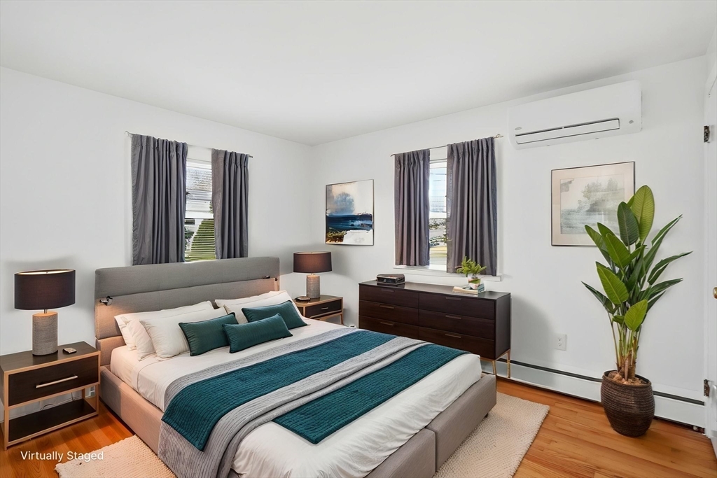 126 Summer Street Boston, MA 02136 - Photo 11 of 28 a bedroom with a bed table flowerpot and window