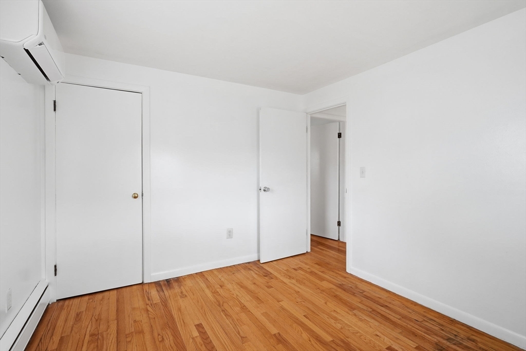 126 Summer Street Boston, MA 02136 - Photo 13 of 28 a view of empty room with wooden floor