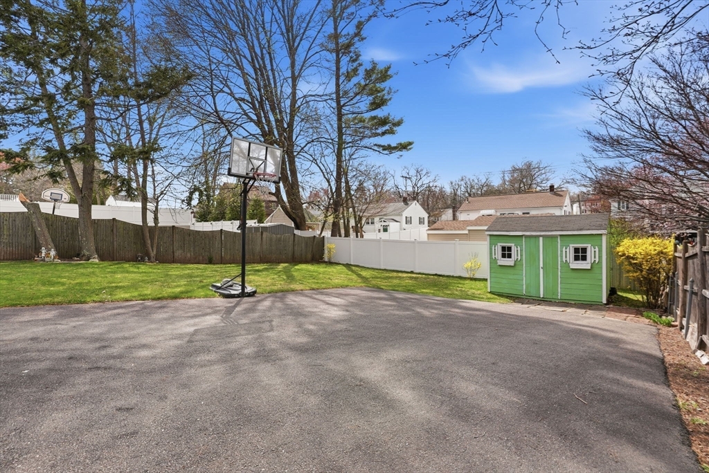126 Summer Street Boston, MA 02136 - Photo 25 of 28 a view of a house with a big yard and large trees
