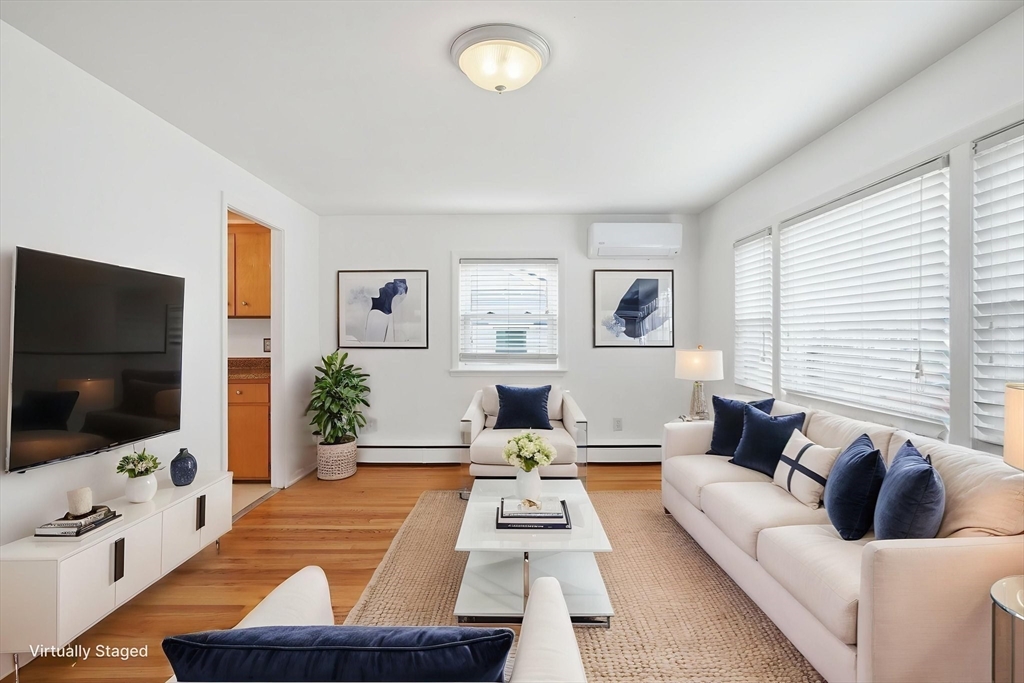 126 Summer Street Boston, MA 02136 - Photo 4 of 28 a living room with furniture and a flat screen tv