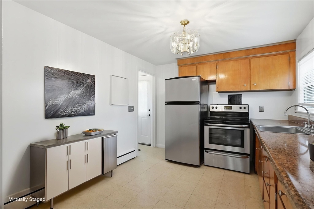126 Summer Street Boston, MA 02136 - Photo 7 of 28 a kitchen with cabinets and stainless steel appliances