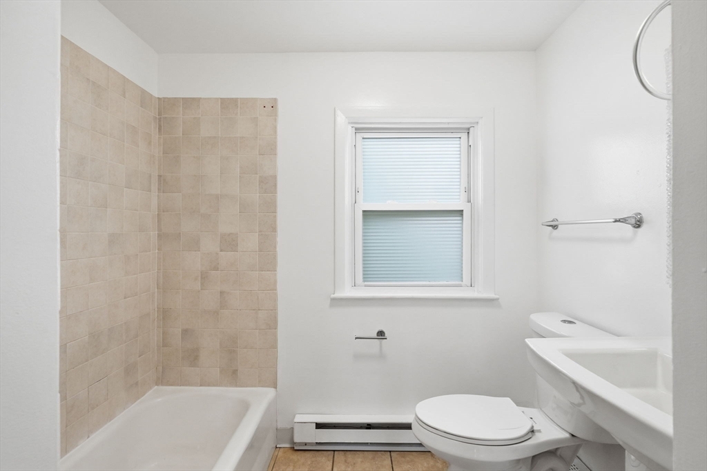 126 Summer Street Boston, MA 02136 - Photo 10 of 28 a bathroom with a toilet a sink and bathtub