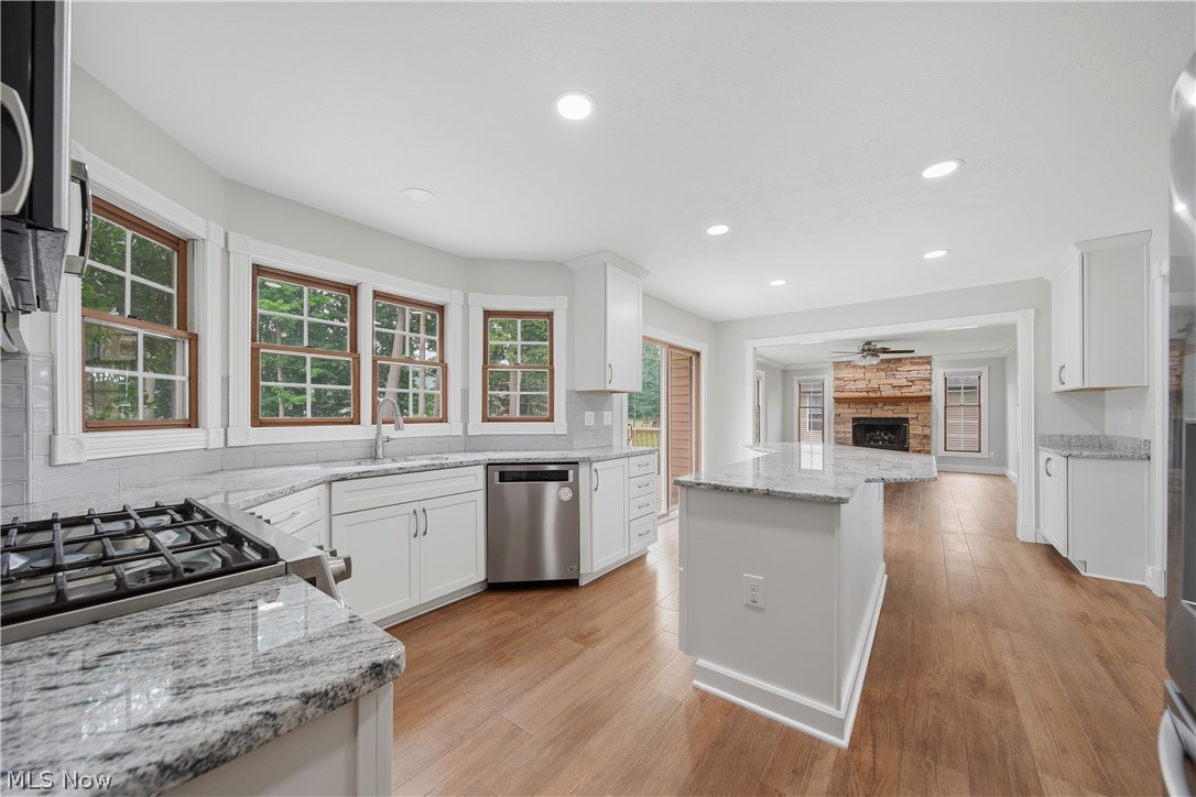 4764 Young Road Stow, OH 44224 - Photo 17 of 41 Spacious kitchen featuring white cabinetry, light granite countertops, stainless steel appliances, and wood-finish flooring