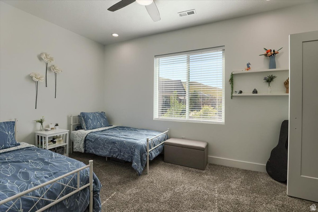 828 South Deer Road Tooele, UT 84074 - Photo 34 of 51 Bright room featuring a window with horizontal blinds, neutral wall paint, and textured carpet flooring
