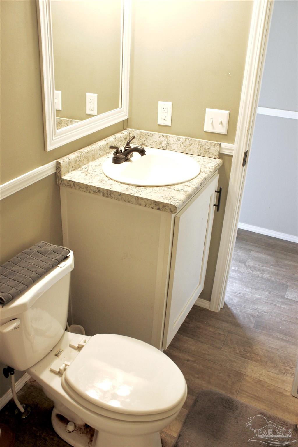 3230 Mason Road McDavid, FL 32568 - Photo 38 of 45 a bathroom with a sink a toilet a mirror and shower