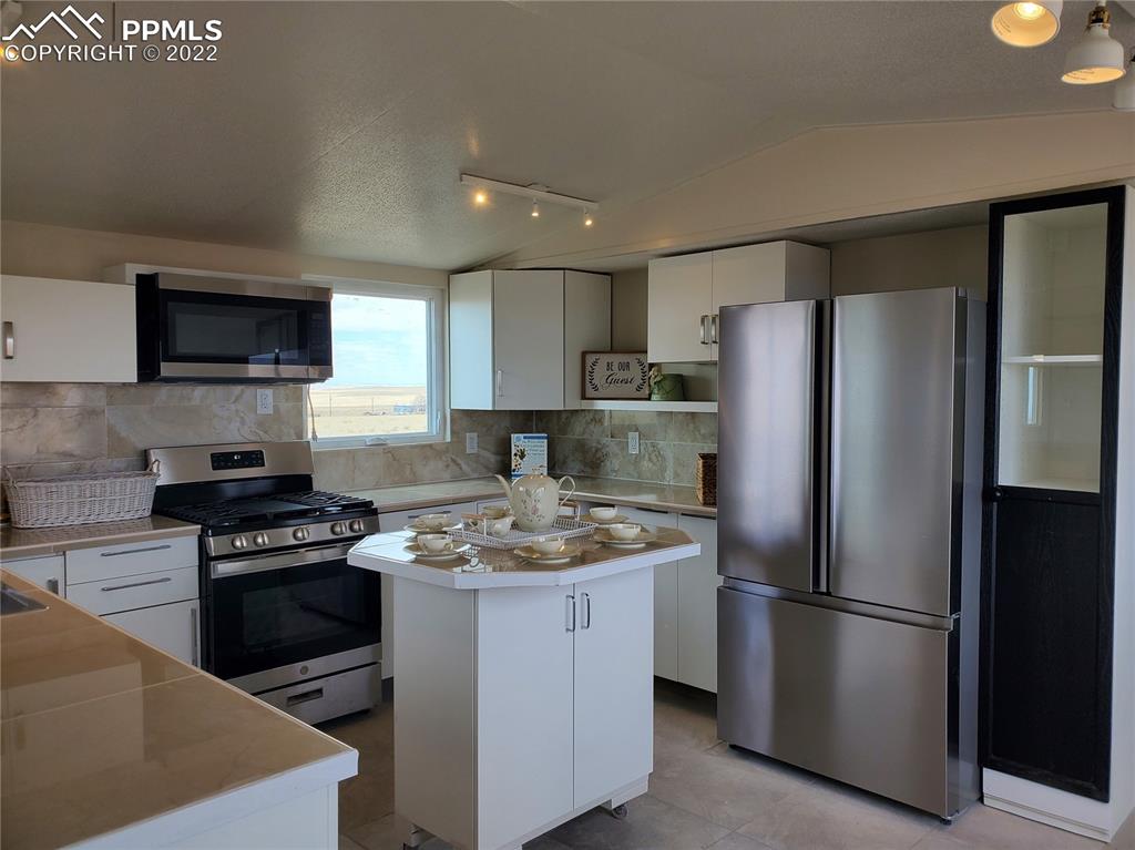 30190 Carl View Yoder, CO 80864 - Photo 8 of 50 a kitchen with a refrigerator stove and microwave