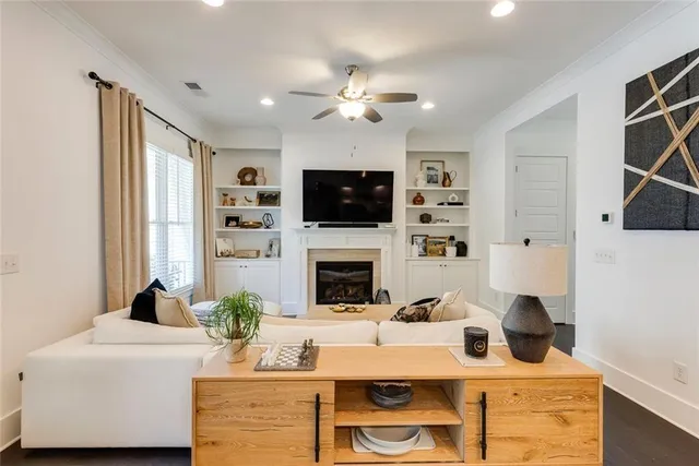 a living room with fireplace furniture and a flat screen tv