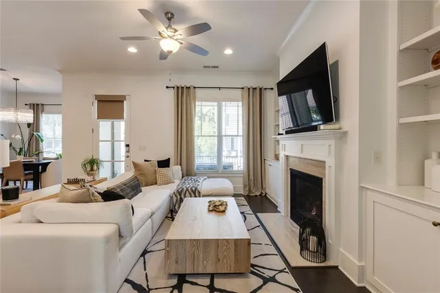 a living room with furniture a fireplace and a flat screen tv