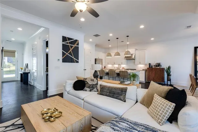a living room with furniture and a chandelier