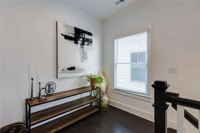 a spacious bedroom with a bed and a flat screen tv