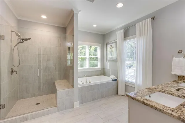 a bathroom with a granite countertop sink a toilet and shower