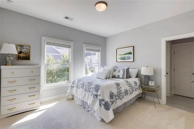 a en suite bathroom with a double vanity sink a mirror and shower