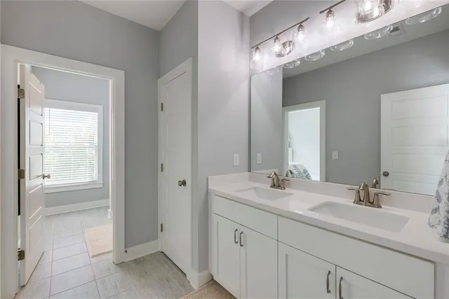 a bathroom with a bathtub next to a window