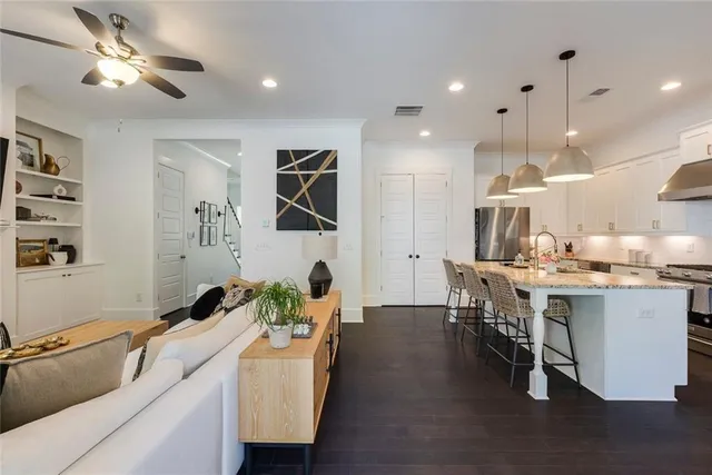a living room with furniture and kitchen view