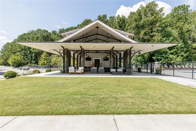 a front view of a house with swimming pool having outdoor seating