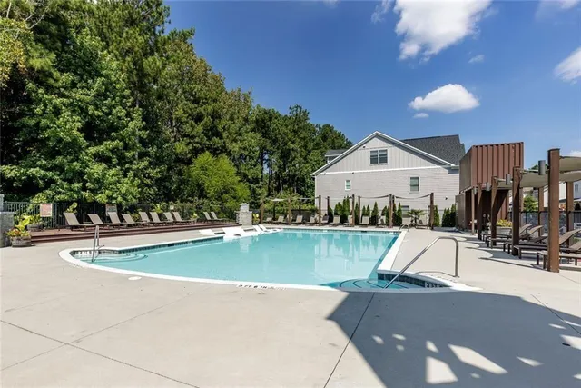 a view of a swimming pool with a bench and wooden fence