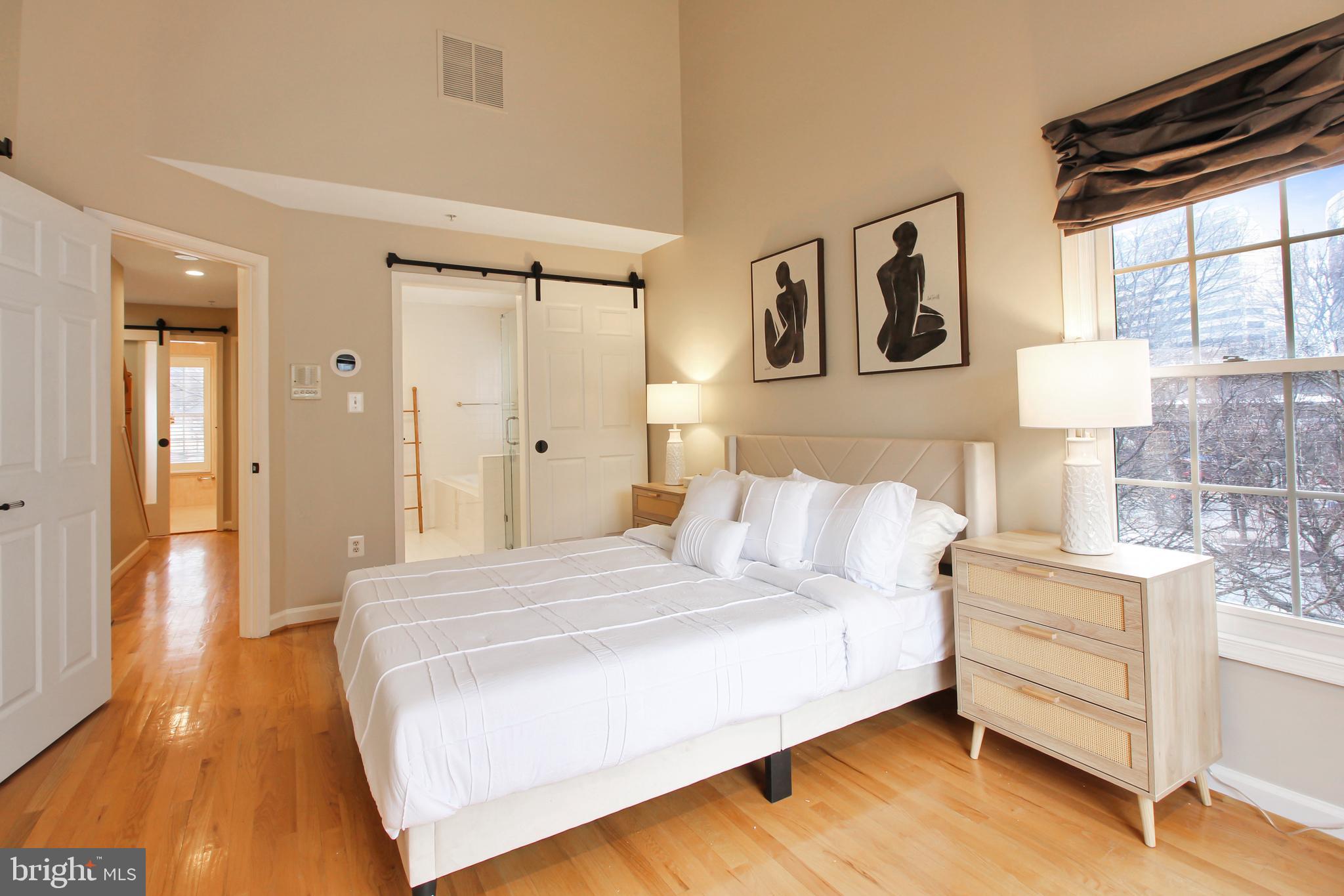 1227 Fidler Lane Silver Spring, MD 20910 - Photo 20 of 33 a bedroom with a bed and wooden floor