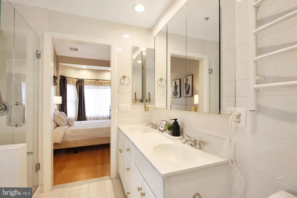 a en suite bathroom with a double vanity sink and a mirror