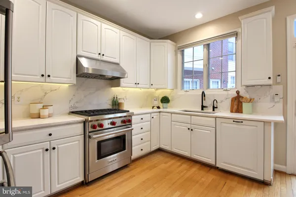 a kitchen with cabinets appliances and a window