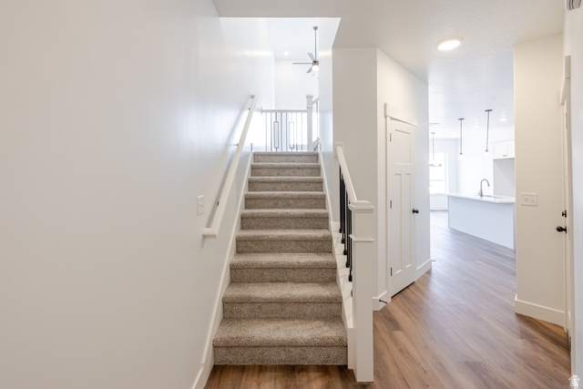 4812 Heartwood Road, Unit 424 Mapleton, UT 84664 - Photo 12 of 20 Staircase with wood finished floors, a ceiling fan, and recessed lighting