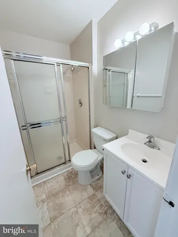 an empty room with a ceiling fan and a window