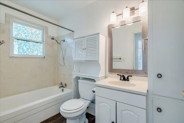 a bathroom with a sink toilet tub and vanity