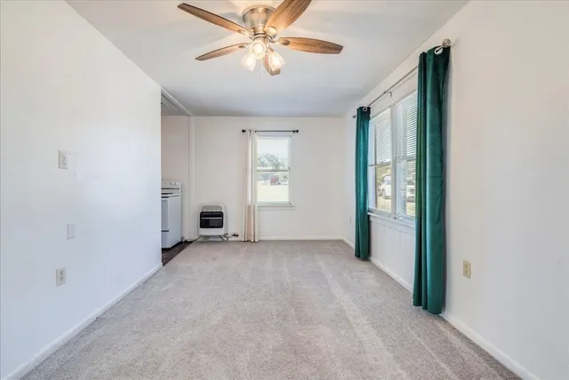 an empty room with chandelier fan