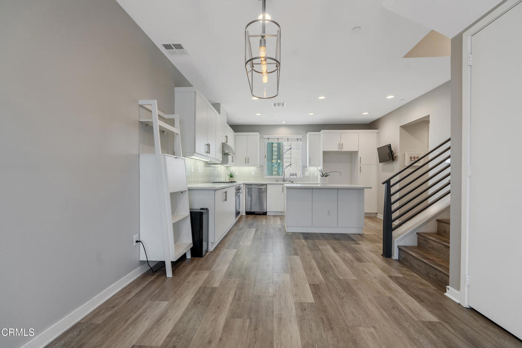1553 Verbena Way Los Angeles, CA 90041 - Photo 15 of 31 a room with stainless steel appliances kitchen island granite countertop a wooden floor and a view of living room