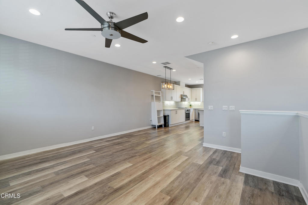 1553 Verbena Way Los Angeles, CA 90041 - Photo 7 of 31 an empty room with wooden floor and a ceiling fan