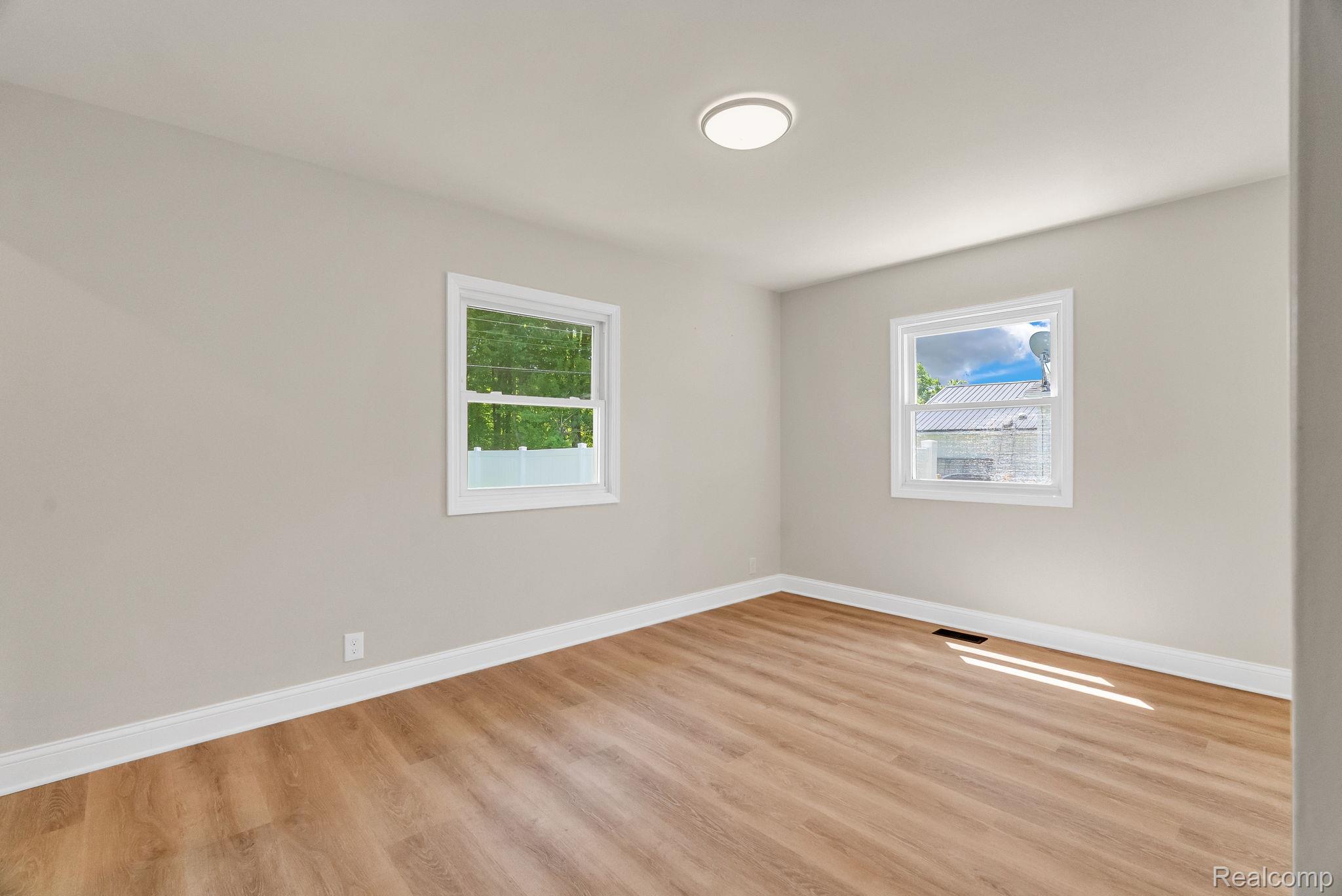 4046 State Road Fort Gratiot, MI 48059 - Photo 21 of 38 Neutral tone walls with wood-finish flooring