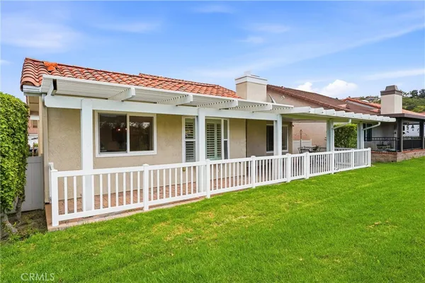 a view of an house with backyard porch and furniture