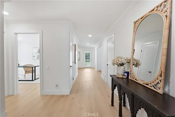 a view of a hallway with furniture and mirror