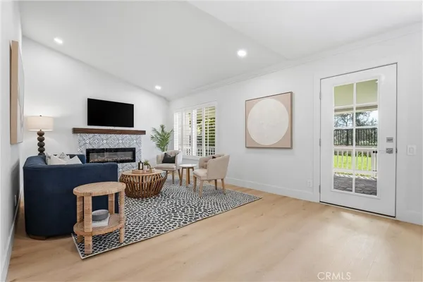 a living room with furniture a fireplace and a flat screen tv