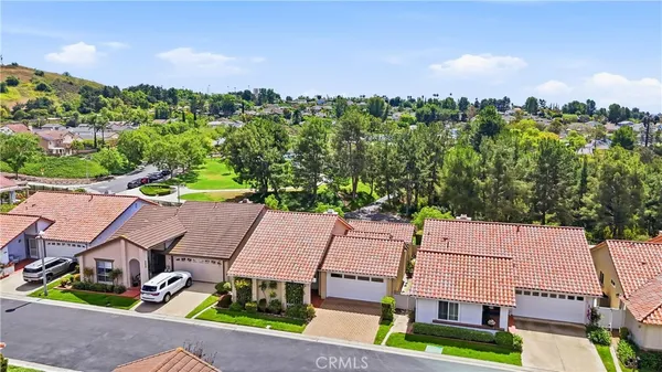 an aerial view of multiple houses with a yard