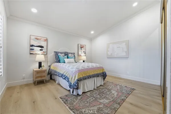 a bedroom with a bed rug and a wall painting