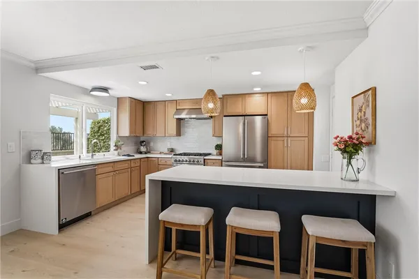 a kitchen with a table chairs sink and cabinets
