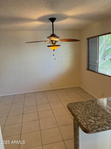 a white refrigerator freezer and a stove sitting inside of a kitchen