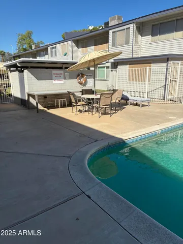 a backyard of a house with table and chairs