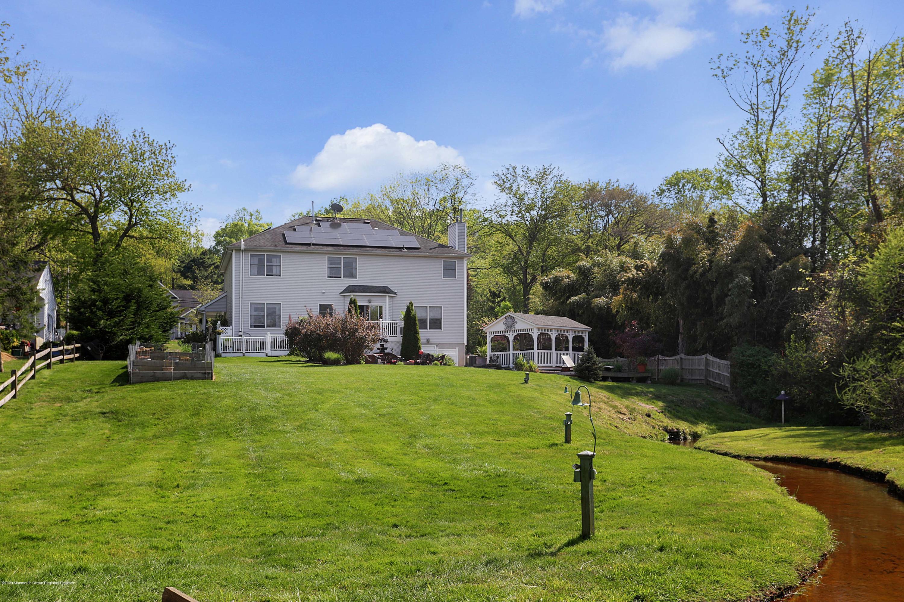 653 Locust Point Road Atlantic Highlands, NJ 07716 - Photo 16 of 57 grass area view toward house