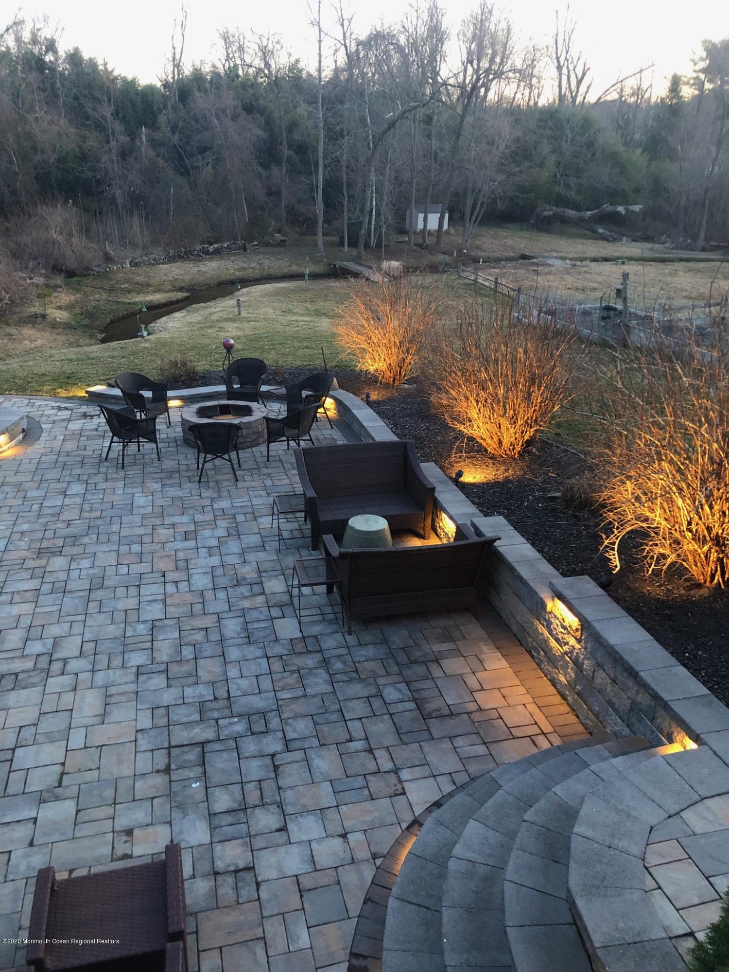 653 Locust Point Road Atlantic Highlands, NJ 07716 - Photo 46 of 57 Paver Patio At Dusk