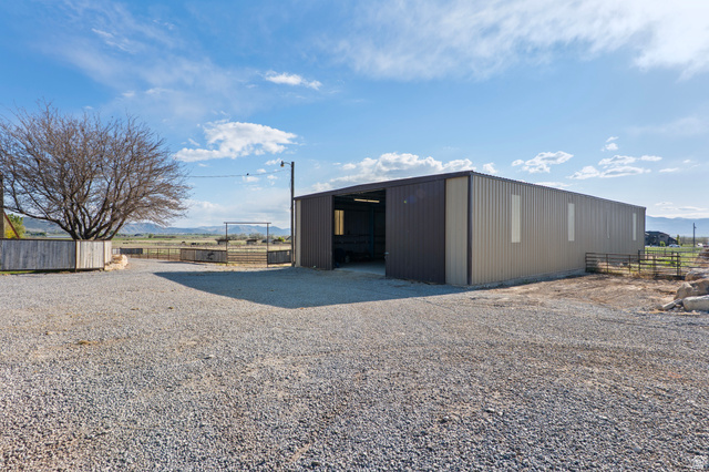 115 East 1600th Street North Santaquin, UT 84655 - Photo 31 of 52 Spacious gravel drive with a large metal-sided outbuilding featuring multiple access points