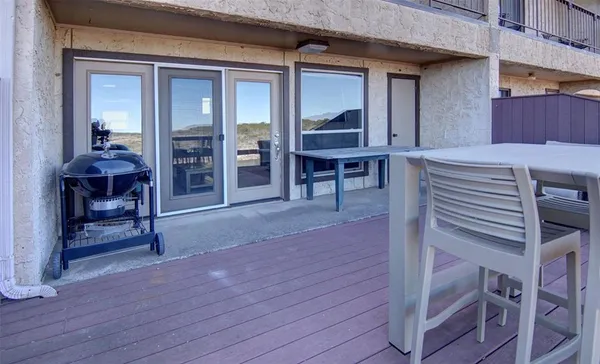a view of a chairs and a table in the patio