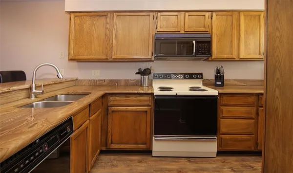 a kitchen with a sink stove and microwave