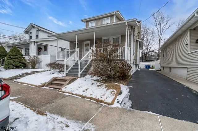 a view of a house with a snow in the yard
