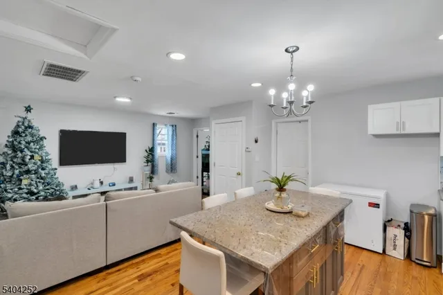 a bedroom with a bed and a flat tv screen on dresser