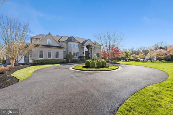 a front view of a house with a garden and yard