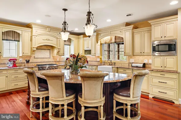 a kitchen with stainless steel appliances granite countertop a sink and cabinets