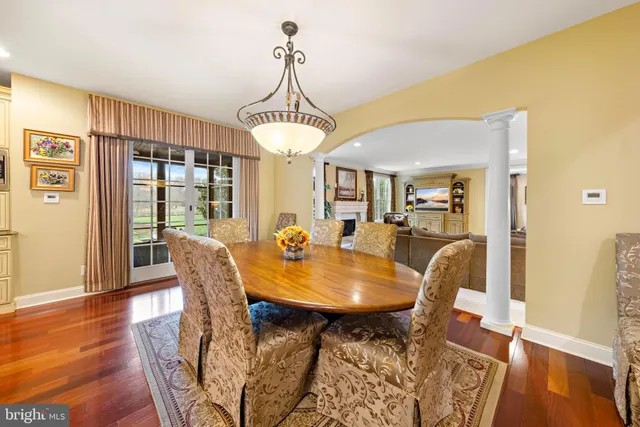 a view of a hallway with wooden floor and a living room